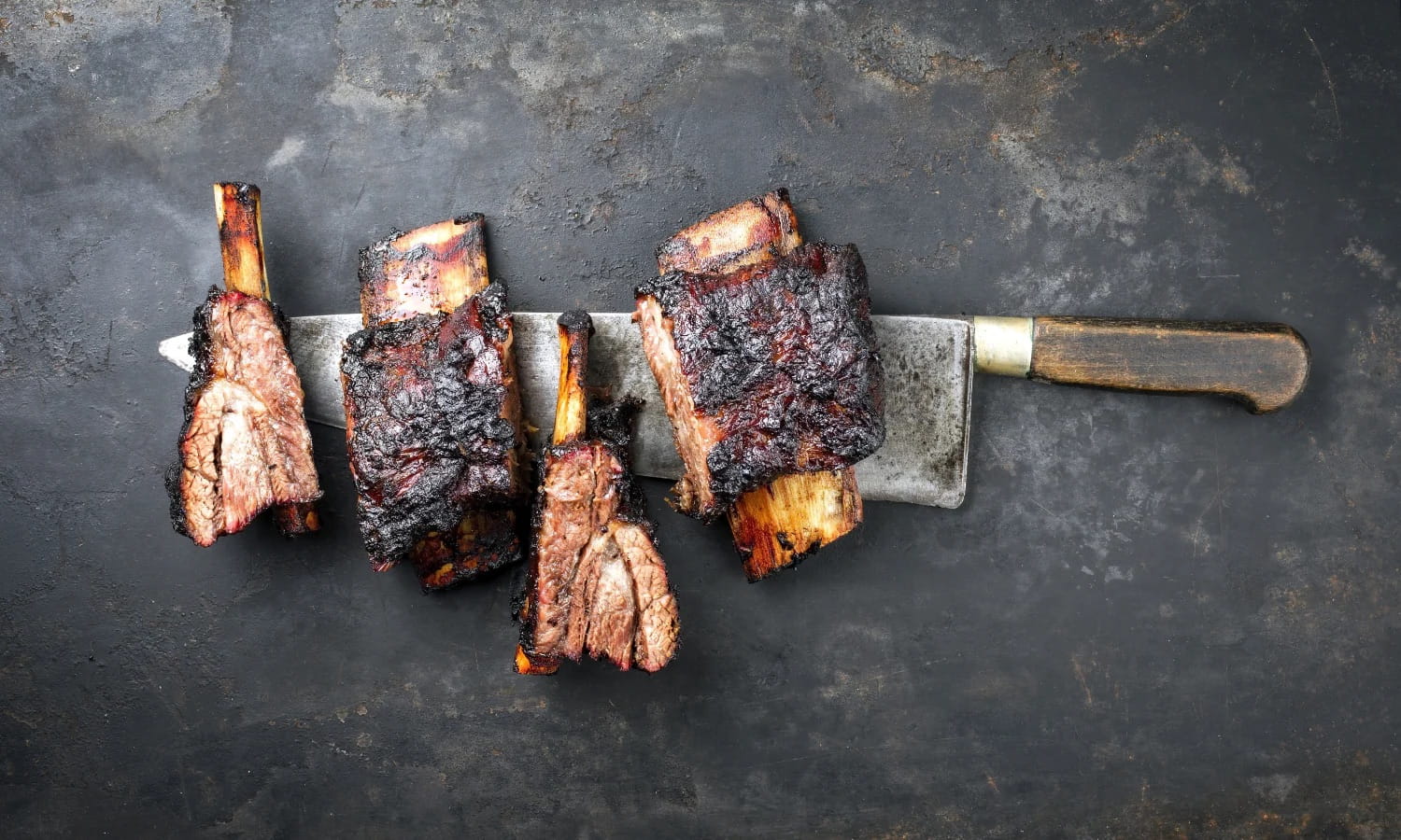 Roasted beef short ribs on a knife